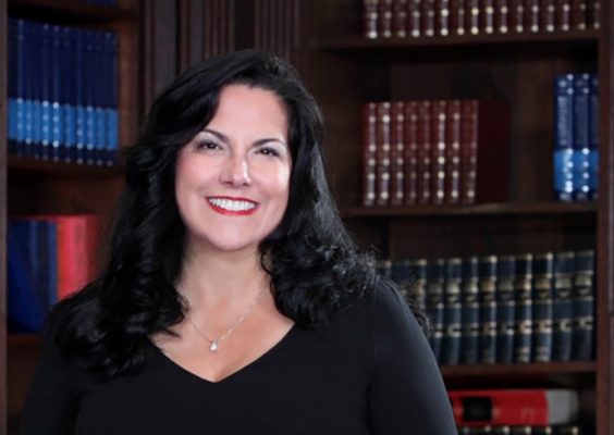 Christine Carona standing in corner of a library