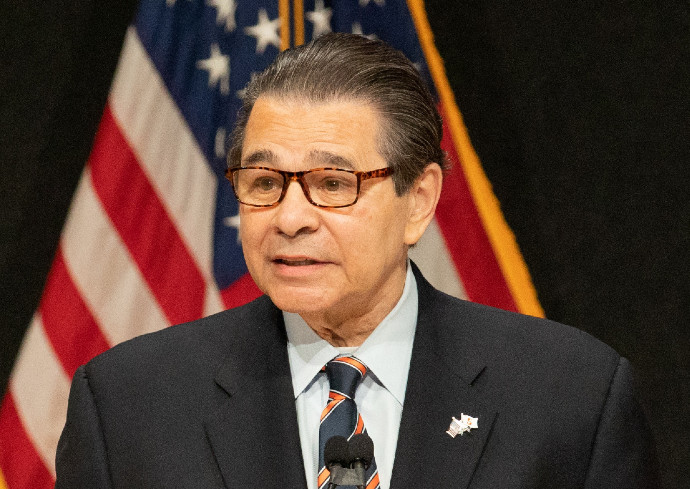 Daniel D'Aniello standing in front of American flag