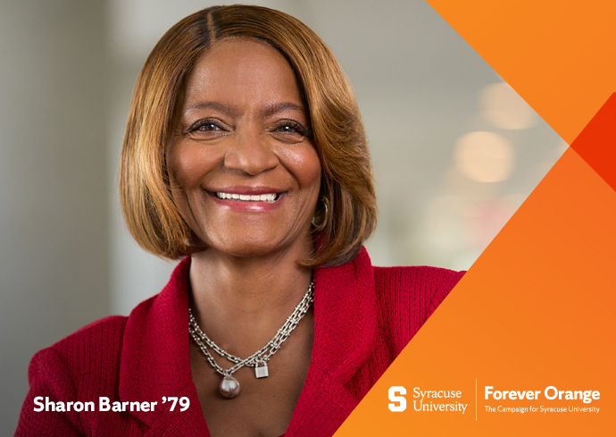 Inside headshot of Sharon Barner wearing a red knit jacket and silver necklaces with orange Forever Orange logo backbround